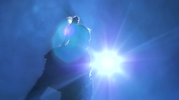 Torero in blue and gold suit or typical spanish bullfighter silhouette on a blue background of smoke. Close up, slow motion. — Stock Video