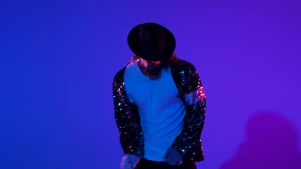 Mladý stylový muž tančící stylově Michael Jackson, reflektor na modrém pozadí. Zavřít, zpomalit.. — Stock video