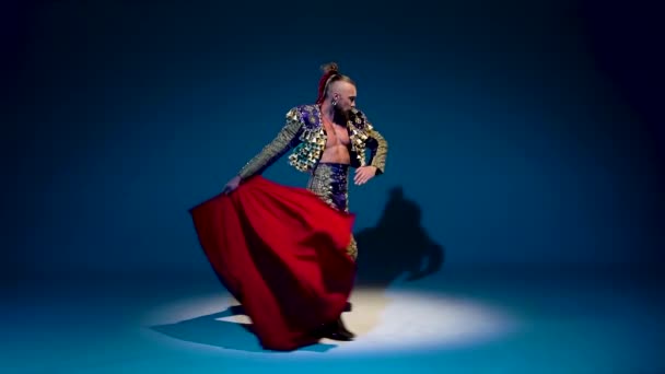 Torero in blue and gold suit or typical spanish bullfighter isolated spotlight on a blue background. Close up, slow motion. — 비디오