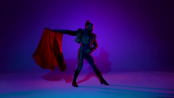 Torero in blue and gold suit or typical spanish bullfighter isolated over on a blue background. Close up, slow motion. — Stock Video