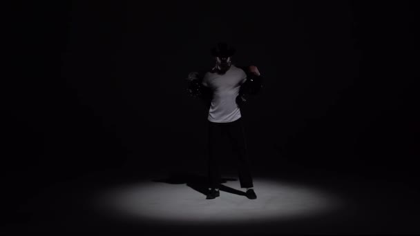 Junger stilvoller Mann, der im Stil von Michael Jackson tanzt, Scheinwerfer auf schwarzem Hintergrund. Nahaufnahme, Zeitlupe. — Stockvideo