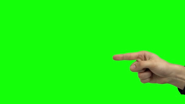 Egy férfi karja mutat valamire. Zöld vászon. Közelről. — Stock videók