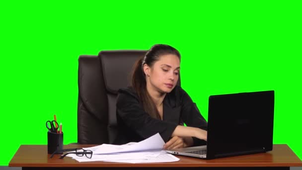 疲惫的女人阅读文件，比较信息与笔记本电脑，并粉碎纸张。 绿色屏幕。 慢动作 — 图库视频影像
