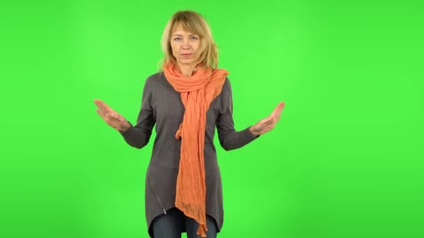 Middle aged blonde woman strictly gesturing with hands crossed making X shape meaning denial saying NO. Green screen — Stock Video