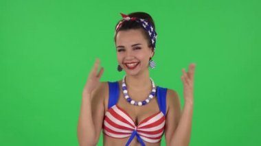 Portrait of beautiful girl in a swimsuit coquettishly is laughing. Green screen