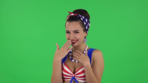 Portrait of beautiful girl in a swimsuit is surprised and rejoicing. Green screen — Stockvideo