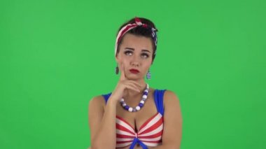 Portrait of beautiful girl in a swimsuit is waiting with boredom. Green screen