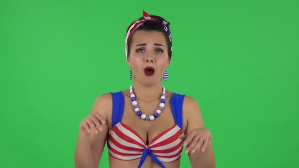 Portrait of beautiful girl in a swimsuit is looking with tenderness with folded arms in front of her. Green screen — Stok video