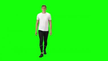 Young man in a white t-shirt, sweatpants and sneakers going against a green background.