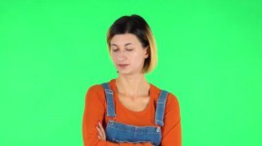 Lovely girl is very offended and looks away then smiles. Green screen