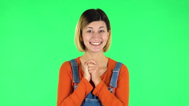 Girl looks with tenderness with folded arms in front of her. Green screen — 图库视频影像