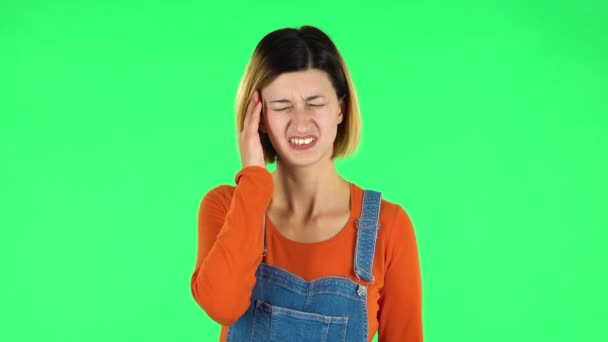 Woman suffering from headache from fatigue. Green screen — Stock Video