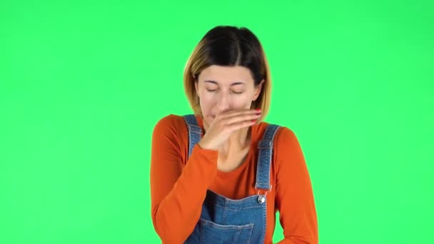 Girl got a cold, sore throat and head, cough on green screen at studio — Stock Video