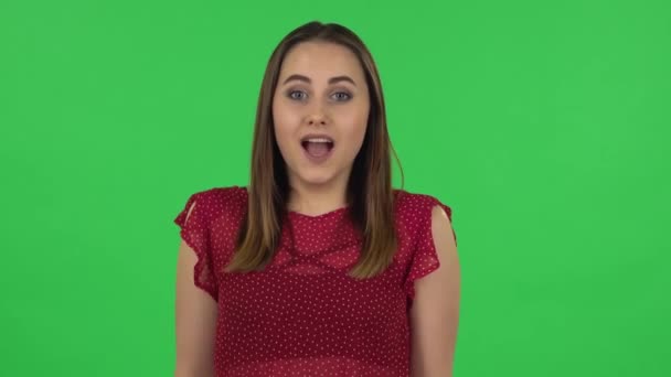 Portrait of tender girl in red dress is waiting in anticipation with pleasure. Green screen — Stock video