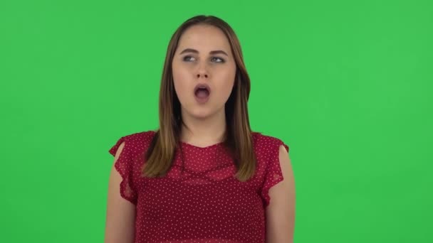 Portrait of tender girl in red dress is waiting. Green screen — Stockvideo