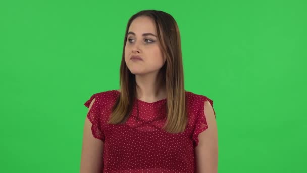 Portrait of tender girl in red dress is waiting. Green screen — Stock Video