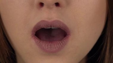 Woman lips with the wow emotion of surprise on a green screen. Close up