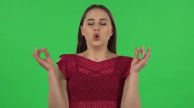 Portrait of tender girl is refusing stress and taking situation, calming down, breathing deeply. Green screen