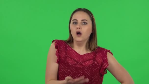 Portrait of tender girl is cooling herself by her hand, suffering from high temperature weather. Green screen — Stockvideo