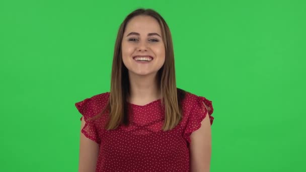 Portrait of tender girl in red dress is laughing. Green screen — ストック動画