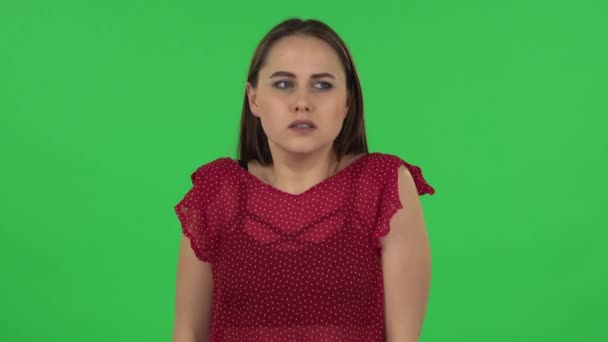 Portrait of tender girl in red dress girl froze and trying to keep warm. Green screen — Stock video