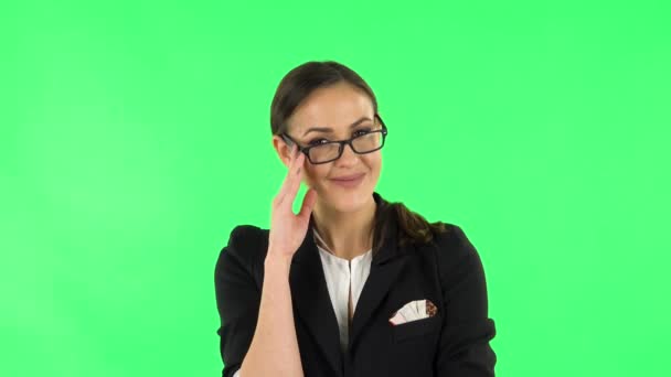 Woman coquettishly smiling while looking at camera. Green screen — Stock Video