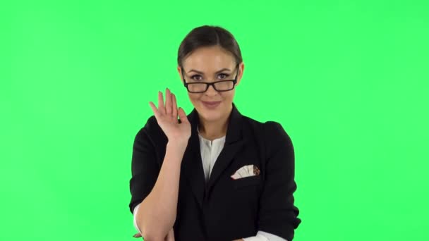 Lovely girl coquettishly smiling, waving hand and showing gesture come here. Green screen — Stock video