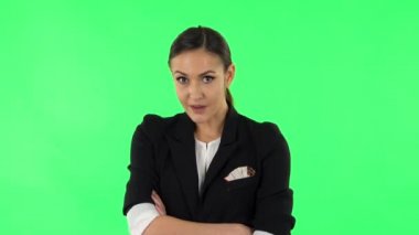 Lovely girl is very offended, looks away and then smiles. Green screen