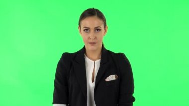 Upset girl looking at the camera with tears in her eyes. Green screen