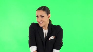 Woman throwing up hands expressing she is innocent, saying oops she doesnt know whats. Green screen