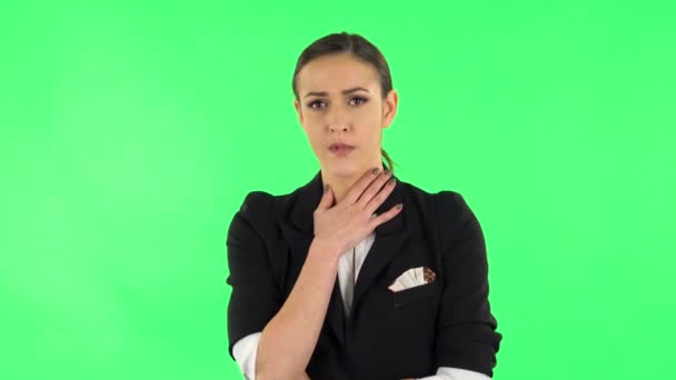 Girl listens to information looking at camera, is shocked and very upset. Green screen — Wideo stockowe