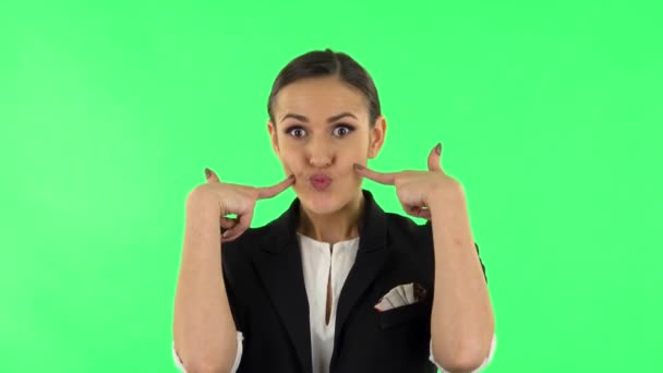 Trendy girl poses for camera makes funny faces. Green screen — Stock Video