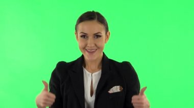 Smiling girl makes gestures fingers: like, ok, victory, rock. Green screen