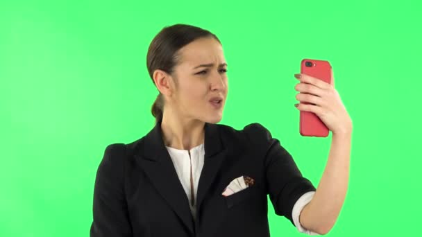 Girl talking for video chat using mobile phone. Green screen — Stock Video