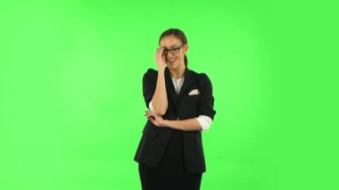 Woman laughing while looking at camera. Green screen