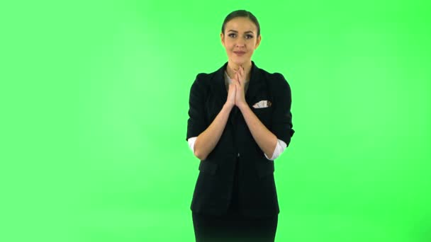 Tender girl with folded arms in front of her and tears in her eyes. Green screen — Stok video