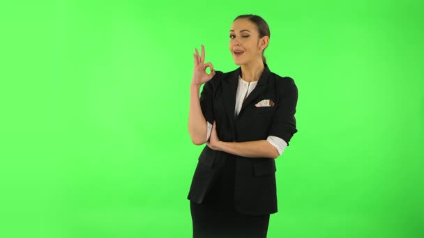 Smiling girl makes sign ok. Green screen — Stock Video