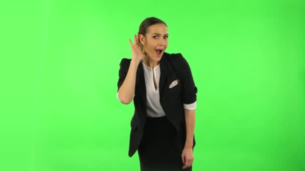 Woman holding hand near ear trying to listen to interesting news expressing communication concept. Green screen — Αρχείο Βίντεο