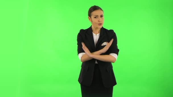 Woman strictly gesturing with hands crossed making X shape meaning denial saying NO. Green screen — Stock Video