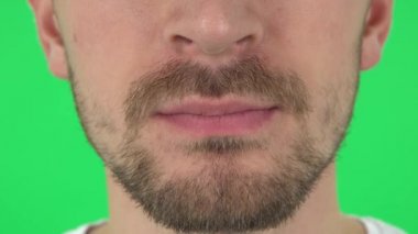 Young man lips with a beard. Close up