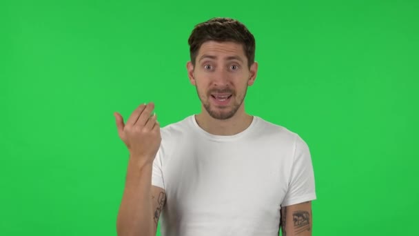 Portrait of confident guy is waving hand and showing gesture come here. Green screen — Stock video