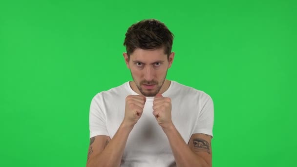 Portrait of confident guy is looking at the camera with excitement, then celebrating his victory triumph. Green screen — Stock Video