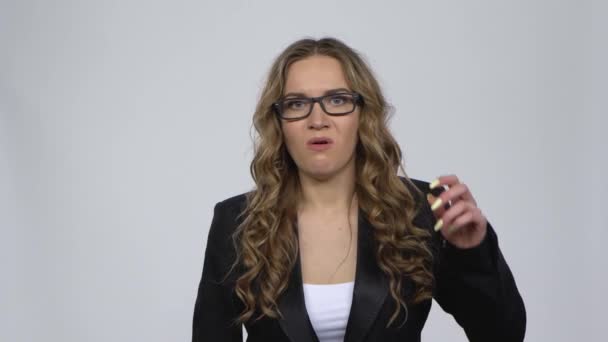 Studio portrait of annoyed woman gesturing in stress expressing irritation and anger, over grey background. — Stock Video