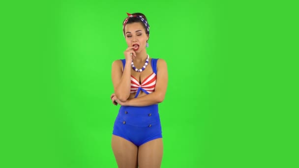 Beautiful girl in a swimsuit coquettishly is smiling. Green screen — Stock Video