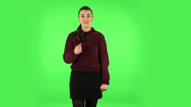 Girl standing arms crossed, nervous. Eye spasm concept. Green screen at studio — Αρχείο Βίντεο