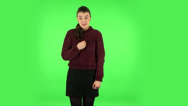 Lovely girl smiles broadly, winks and makes sign ok. Green screen — Stockvideo