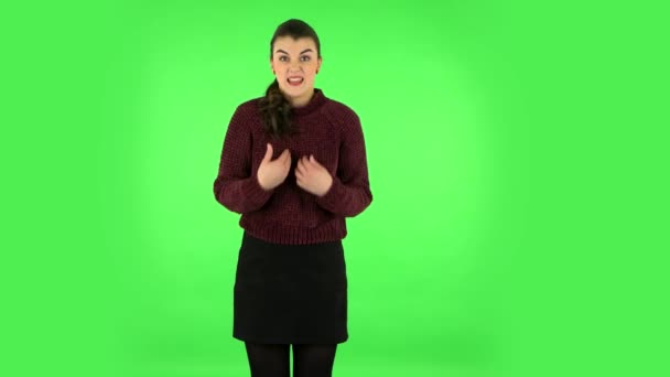 Woman is upset and tired on green screen at studio. Green screen — 图库视频影像