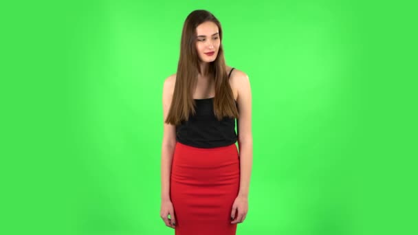 Charming girl looks around and whispers the secret and making a hush gesture. Green screen — Stock Video