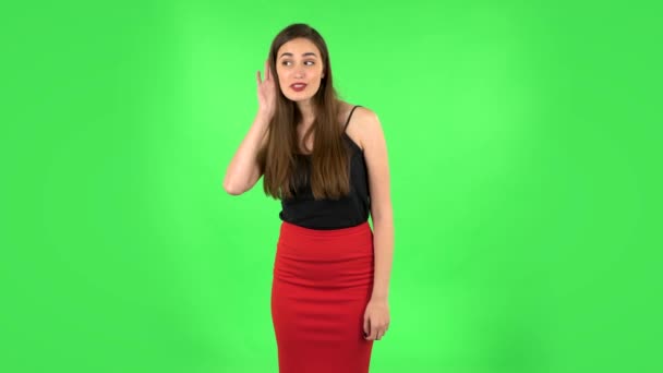Woman holding hand near ear trying to listen interesting news expressing communication concept and gossip. Green screen — Stock Video