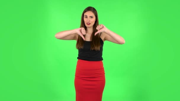 Unhappy girl showing thumbs down gesture. Green screen — Stock Video